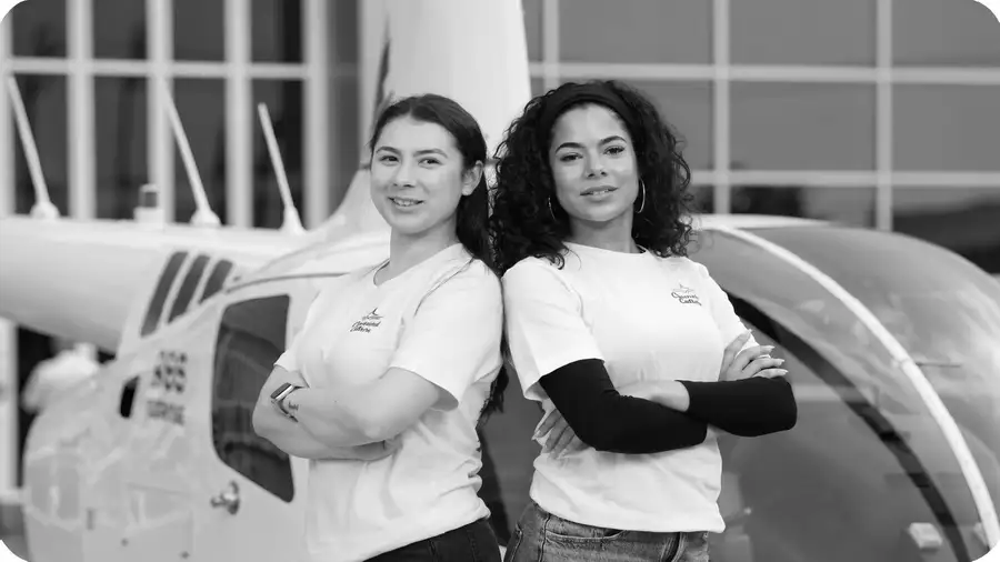 Man in flight jacket looking skyward in front of helicopter — Crosswind Culture aviation apparel